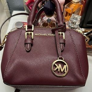 Authentic Plum mini Michael Kors bag.